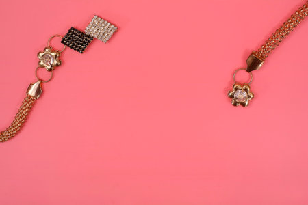 Gold necklaces isolated on a pink backgroundの写真素材