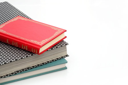 Stack of books in color covers with white sheets isolated on a white background