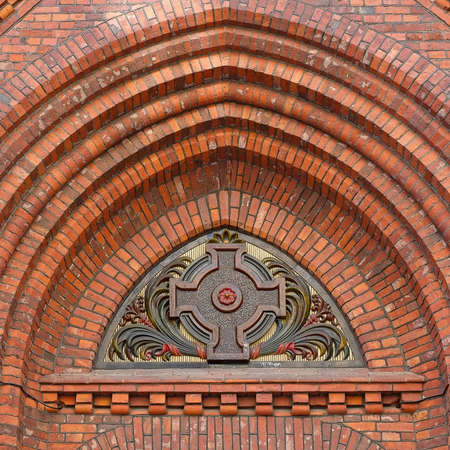 Isolated decor with a cross of an old brick Lutheran churchの写真素材