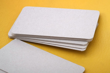 Template of business kraft-paper cards isolated on yellow background to demonstrate the design of the customerの写真素材