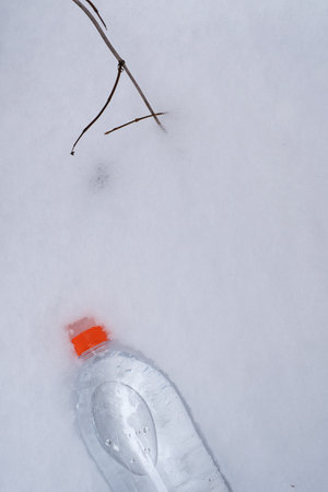 A bottle of drinking water in the snow. advertising posterの写真素材