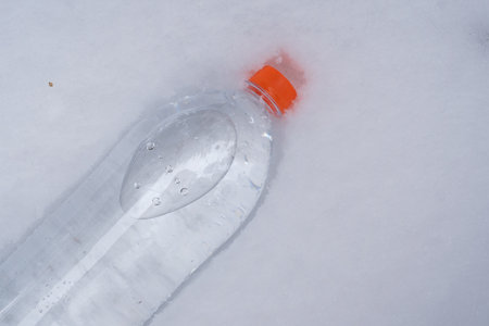 A bottle of drinking water in the snow. advertising posterの写真素材