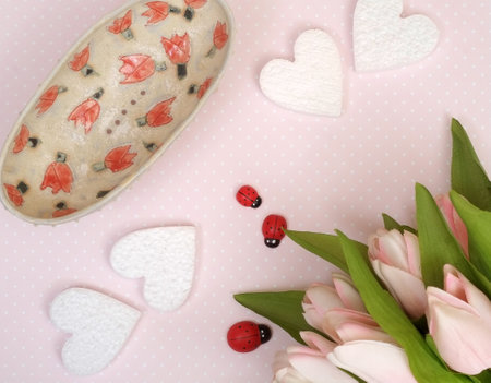Delicate maiden Composition with hearts and a bouquet of tulips on a pink abstract backgroundの写真素材