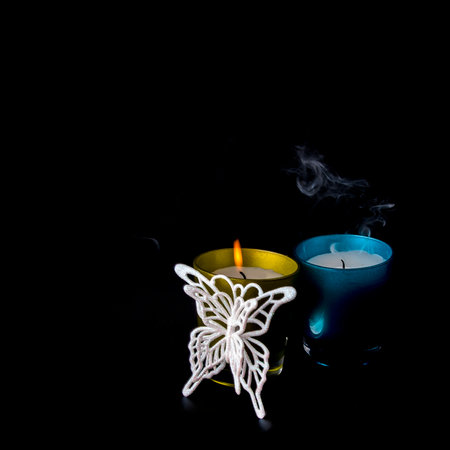 New Year's still life with candles and Christmas tree decorations on a black background (poster mockup)の写真素材