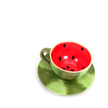 A cup and saucer in the form of a watermelon isolated on white backgroundの写真素材