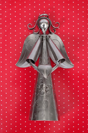 Metal angel isolated on a red backgroundの写真素材