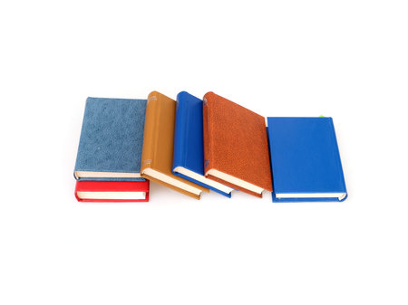 Stack of red, blue, yellow and brown books isolated on a white backgroundの写真素材