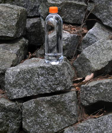 Water bottle standing in the stones. Package mockup designの写真素材