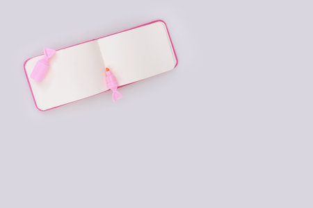 Composition (mockup) with pink notepad and pink marker isolated on white backgroundの写真素材