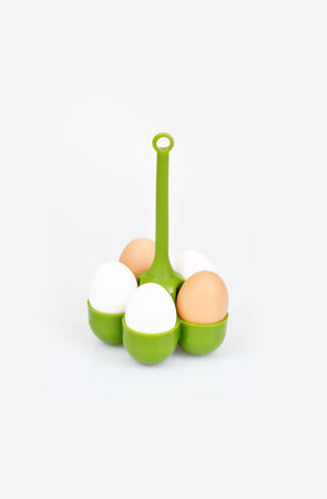 Silicone green egg cooker isolated on white background