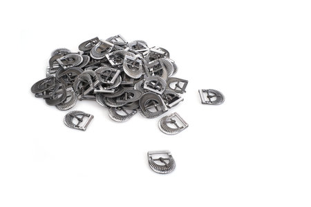 Pile of buckles for clothes, shoes, belts, bags isolated on white background
