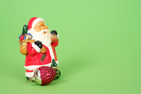 Ceramic Santa Claus isolated on a green backgroundの写真素材