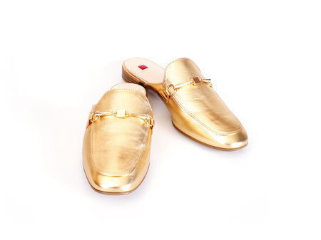 Golden leather mules isolated on white backgroundの写真素材