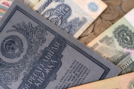 Old Soviet banknotes, coins and paper passbook. Isolated background