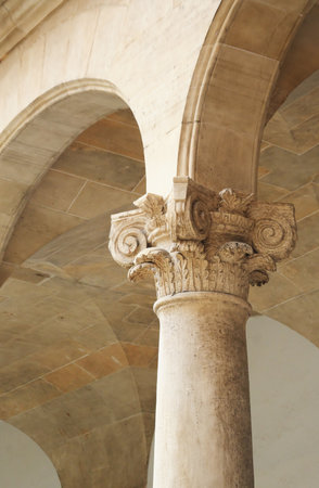 Antique Corinthian column. Isolated background in warm colorsの写真素材