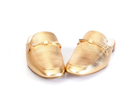 Golden leather mules isolated on white backgroundの写真素材