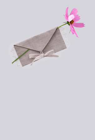 Textile, fabric, linen envelope of natural color with hand embroidery and beautiful pink flower...