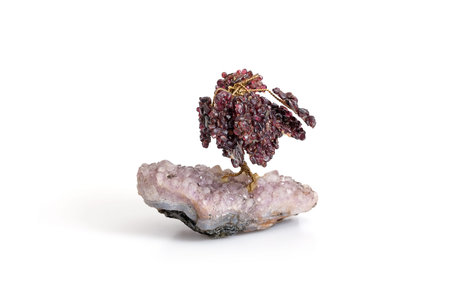 Natural amethyst druse and decorative garnet tree isolated on white background