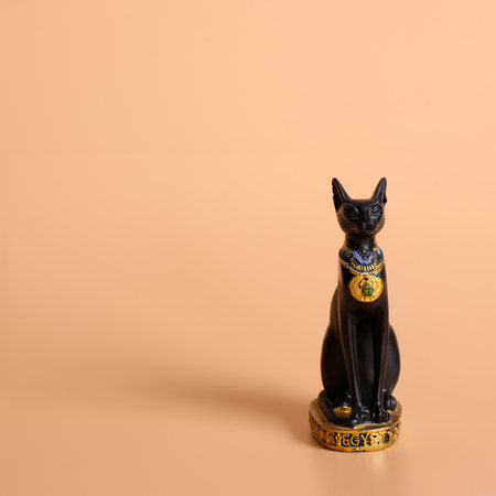 Souvenir from Egypt (goddess Bastet in the form of a black cat) isolated on a orange backgroundの写真素材