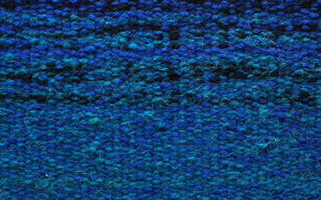 Isolated surface of handmade carpet in blue tones