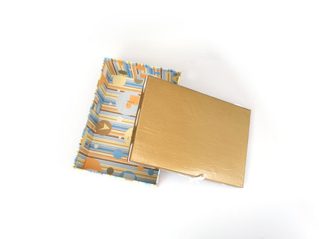 One open gift gold-colored box with silk ribbon isolated on a white background. Flat lay view
