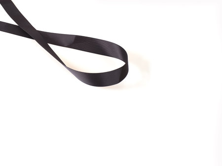 Decorative black silk ribbon isolated on white background. Design element with clipping pathの写真素材