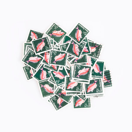 Background of bright New Zealand postage stamps depicting the scarlet parrot fishの写真素材