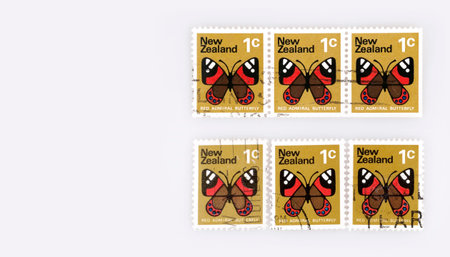 Background of bright New Zealand postage stamps depicting the red admiral butterflyの写真素材
