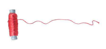 Spool of red silk thread isolated on a white backgroundの写真素材
