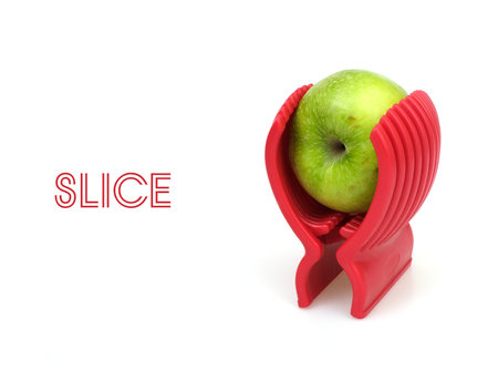 Ripe green apple and red slicer isolated on white background
