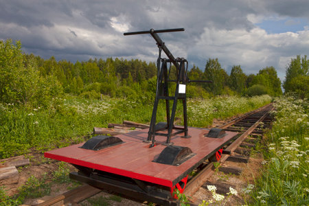 An outdoor shot of a vintage railway maintenance cart sits on train tracks amidst a grassy field and forest. Pereslavl-Zalessky (Russia), Railway Museum "Kukushka"の写真素材