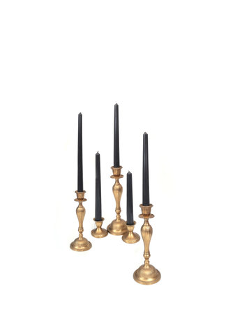 Row of gold candlesticks with black candles isolated on white background, cutout ready. Extremely high resolutionの写真素材