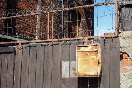a wooden fence with a old mailboxの写真素材