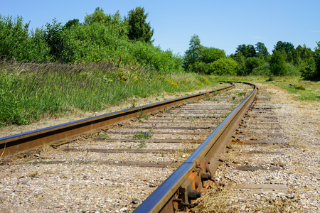 Curving rail line winds its way through trees and forests.の写真素材