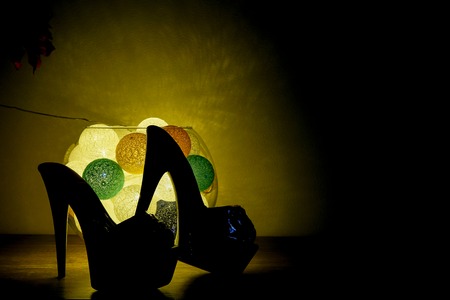 background, closeup view highheel shoes with romantic luminaireの写真素材