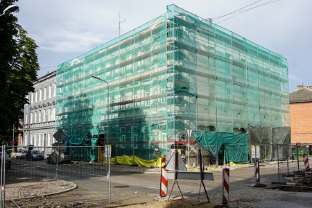 repair of a urban apartment building facade, underground communications repair worksの写真素材