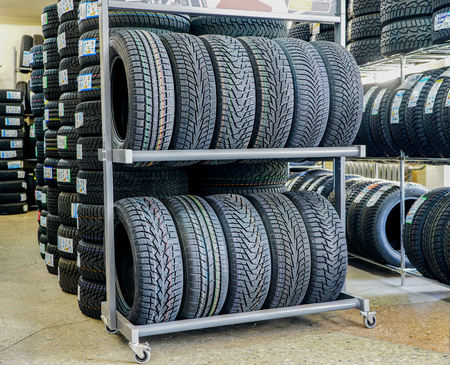 a lot of new winter tires, tire shop in the backgroundの写真素材