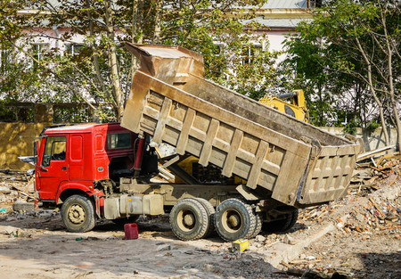 red tipper truck with a raised body on construction siteの写真素材