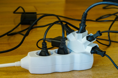 Multi socket with connected power Strip with a bunch of plugs on blurred backgroundの写真素材