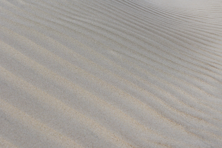 Awesome background of sand , summer beach closeup view, wind formed reliefの写真素材