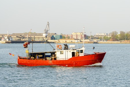 A small fishing trawler returns to the harbourの写真素材