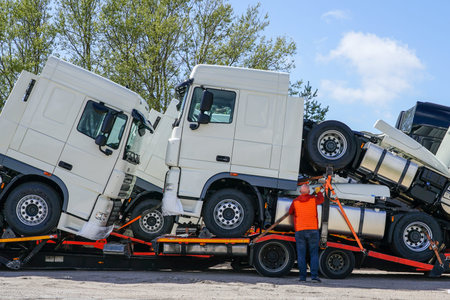 brand new trucks on a carrier truck, that delivers them to customers