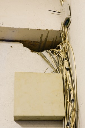 chaos of tangled network cables and wires in server roomの写真素材