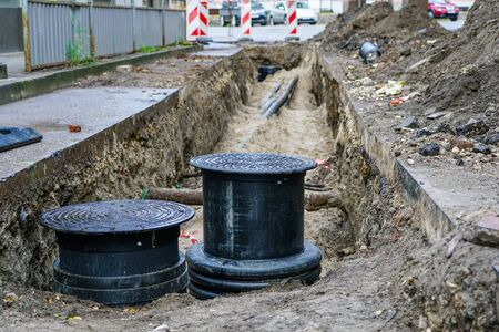 repair, insulation and replacement of underground sewerage pipes network on the city streetの写真素材