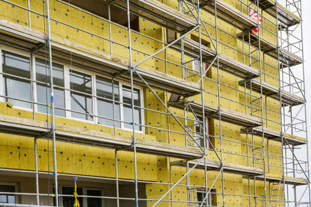 scaffolding arround the house to install thermal insulation of the apartment building facade