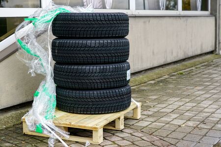delivery of a new set of winter tires to the tire shop, placed on a wooden palletの写真素材
