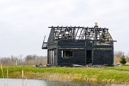 burnt down two storey wooden house in rural areaの写真素材