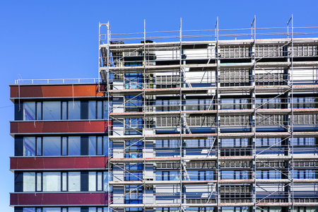 renovation of the facade of a house and thermal insulation using scaffolding