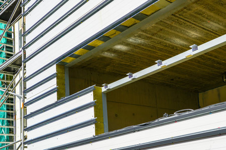 construction of a new modern highly energy efficient house, covering of the facade with sandwich panelsの写真素材