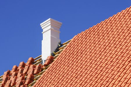 restoration of a historic wooden house, chimney repair and replacement of roof clay tilesの写真素材